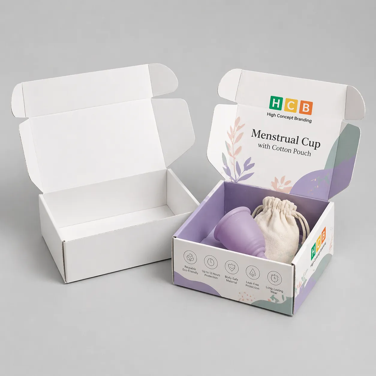 Two flat cardboard mailing boxes, one blank and one decorated with pink floral designs and logos. class=